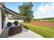 Outdoor patio featuring comfortable seating with a retractable awning and well-manicured lawn at 15411 Taurus Ct, Mascotte, FL 34753