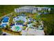 Aerial view of The Grove Resort & Water Park featuring pools, slides, and lush landscaping at 15695 Grove Resort Ave # 4412, Winter Garden, FL 34787