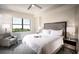 Inviting bedroom with a plush bed, elegant decor, and a serene view, creating a relaxing and comfortable retreat at 15695 Grove Resort Ave # 4412, Winter Garden, FL 34787