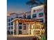 The Terraces at the Grove Resort boasts a modern, multi-story facade with inviting, well-lit entrance and manicured landscaping at 15695 Grove Resort Ave # 4412, Winter Garden, FL 34787