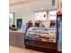 Bright cafe area with a display case filled with sandwiches, salads, and drinks at 15695 Grove Resort Ave # 4412, Winter Garden, FL 34787