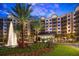 Hotel exterior with fountain and lush landscaping showcasing the entrance and palm trees at 15695 Grove Resort Ave # 4412, Winter Garden, FL 34787