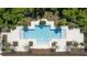 Aerial view of a modern community pool with pristine turquoise water and ample deck space surrounded by lush landscaping at 15695 Grove Resort Ave # 4412, Winter Garden, FL 34787
