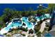 Aerial view of a stunning resort pool area with lush landscaping and sun loungers, offering a luxurious vacation experience at 15695 Grove Resort Ave # 4412, Winter Garden, FL 34787