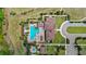 A high angle view of a community clubhouse with pools, lush greenery, and a nearby parking area at 15946 Marina Bay Dr, Winter Garden, FL 34787