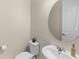 Cozy powder room with modern fixtures, round mirror and elegant decor at 15946 Marina Bay Dr, Winter Garden, FL 34787