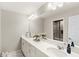 Bright bathroom featuring a spacious vanity with dual sinks and a large mirror at 15946 Marina Bay Dr, Winter Garden, FL 34787