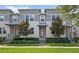Charming gray and white townhome featuring a manicured lawn and inviting front entrance at 15946 Marina Bay Dr, Winter Garden, FL 34787