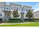 Beautiful townhome featuring a modern exterior and a meticulously landscaped front yard at 15946 Marina Bay Dr, Winter Garden, FL 34787