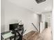 Upstairs landing with a small work area and view of a hallway with a bathroom at 15946 Marina Bay Dr, Winter Garden, FL 34787
