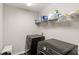 Practical laundry room equipped with modern washer and dryer units and shelving for storage at 15946 Marina Bay Dr, Winter Garden, FL 34787
