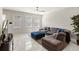 Cozy living room with a plush sectional, ottoman, and large windows offering natural light at 15946 Marina Bay Dr, Winter Garden, FL 34787