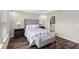 Relaxing main bedroom with a tray ceiling, a gray upholstered bed, and ensuite bathroom access at 15946 Marina Bay Dr, Winter Garden, FL 34787