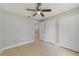Bedroom with closet and access to hallway offers tile floors and ceiling fan at 160 Conch Dr, Kissimmee, FL 34759