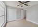 Bedroom with large closet, ceiling fan, and tile flooring provides ample storage and comfort at 160 Conch Dr, Kissimmee, FL 34759