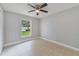 This is a standard bedroom with a window offering a view of the yard, complemented by tile floors at 160 Conch Dr, Kissimmee, FL 34759