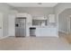 Well-equipped kitchen with stainless steel appliances and modern white cabinets, adjacent dining space at 160 Conch Dr, Kissimmee, FL 34759