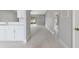 Modern kitchen with white cabinets and stainless steel appliances, adjoining spacious living area at 160 Conch Dr, Kissimmee, FL 34759