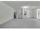 Bright laundry room area with washer, dryer, and water heater featuring white-painted walls and grey floor at 160 Conch Dr, Kissimmee, FL 34759