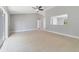 Open living room with tile floors, and natural light, sliding doors for backyard access at 160 Conch Dr, Kissimmee, FL 34759