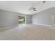 Bright living room with a ceiling fan and sliding glass doors leading to the backyard at 160 Conch Dr, Kissimmee, FL 34759