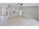 Bright and airy living room with neutral paint, tile flooring and an open layout to the kitchen at 160 Conch Dr, Kissimmee, FL 34759