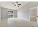 Main bedroom with tile flooring, ceiling fan, and sliding glass door with backyard view at 160 Conch Dr, Kissimmee, FL 34759