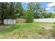 Fenced backyard with shed and young trees at 17 S Aurora Dr, Apopka, FL 32703