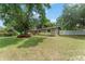 Front yard with mature trees and shrubs at 17 S Aurora Dr, Apopka, FL 32703