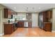 A kitchen featuring stainless steel appliances, wood cabinets with dark countertops, and wood floors at 17 S Aurora Dr, Apopka, FL 32703