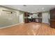 A spacious kitchen with wood floors, stainless steel appliances, and wood cabinets with dark countertops at 17 S Aurora Dr, Apopka, FL 32703