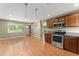 Open kitchen featuring stainless steel appliances, wood cabinets, and wood-look flooring at 17 S Aurora Dr, Apopka, FL 32703