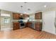 Well-equipped kitchen boasting stainless steel appliances, wood cabinets, and a bright, airy atmosphere at 17 S Aurora Dr, Apopka, FL 32703
