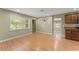 Open-concept space with wood-look floors, leading to the kitchen with stainless appliances and wood cabinetry at 17 S Aurora Dr, Apopka, FL 32703