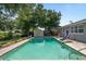 Backyard pool with slide surrounded by lush landscaping and ample patio space at 217 Spencer St, Orlando, FL 32839