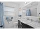 Bathroom showcasing a black vanity with a marble countertop and a framed mirror above the toilet at 217 Spencer St, Orlando, FL 32839