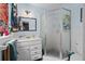 Well-lit bathroom featuring a shower, vanity, sink, mirror, and decorative accents at 217 Spencer St, Orlando, FL 32839