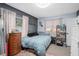 Tranquil bedroom featuring a cozy bed, decorative shelving, and an area rug at 217 Spencer St, Orlando, FL 32839