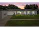 Charming single-story home with a well-manicured lawn and inviting facade at sunset at 217 Spencer St, Orlando, FL 32839