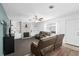 Cozy living room with a brick fireplace, built-in shelves, plush seating, and ceiling fan at 217 Spencer St, Orlando, FL 32839