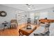 Inviting living room with hardwood floors, large windows, and views of the dining area with a white dining set at 217 Spencer St, Orlando, FL 32839