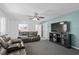 Comfortable living room with modern TV, ceiling fan, and plush leather recliners at 217 Spencer St, Orlando, FL 32839