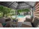 Inviting pool area with a covered patio and outdoor seating for relaxation at 217 Spencer St, Orlando, FL 32839