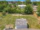 Aerial view showcases the backyard and surrounding greenery, providing a sense of privacy and tranquility at 221 Golden Days Dr, Casselberry, FL 32707