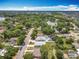 Aerial view highlights the home's location in a community with mature trees and close to the lake at 221 Golden Days Dr, Casselberry, FL 32707