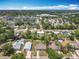 An aerial view of a neighborhood showcasing single-Gathering homes, tree-lined streets, and community amenities at 221 Golden Days Dr, Casselberry, FL 32707