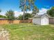 Backyard featuring a white storage shed and a lawn, showing potential for gardening and outdoor enjoyment at 221 Golden Days Dr, Casselberry, FL 32707