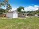 The home's backyard features a storage shed and a grassy area, offering space for outdoor activities and relaxation at 221 Golden Days Dr, Casselberry, FL 32707