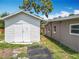 Exterior view of a shed and the back of the house, displaying the spacious backyard with its landscaping potential at 221 Golden Days Dr, Casselberry, FL 32707