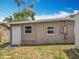 Backyard with a door to the home's interior, complemented by outdoor features and plenty of natural light at 221 Golden Days Dr, Casselberry, FL 32707